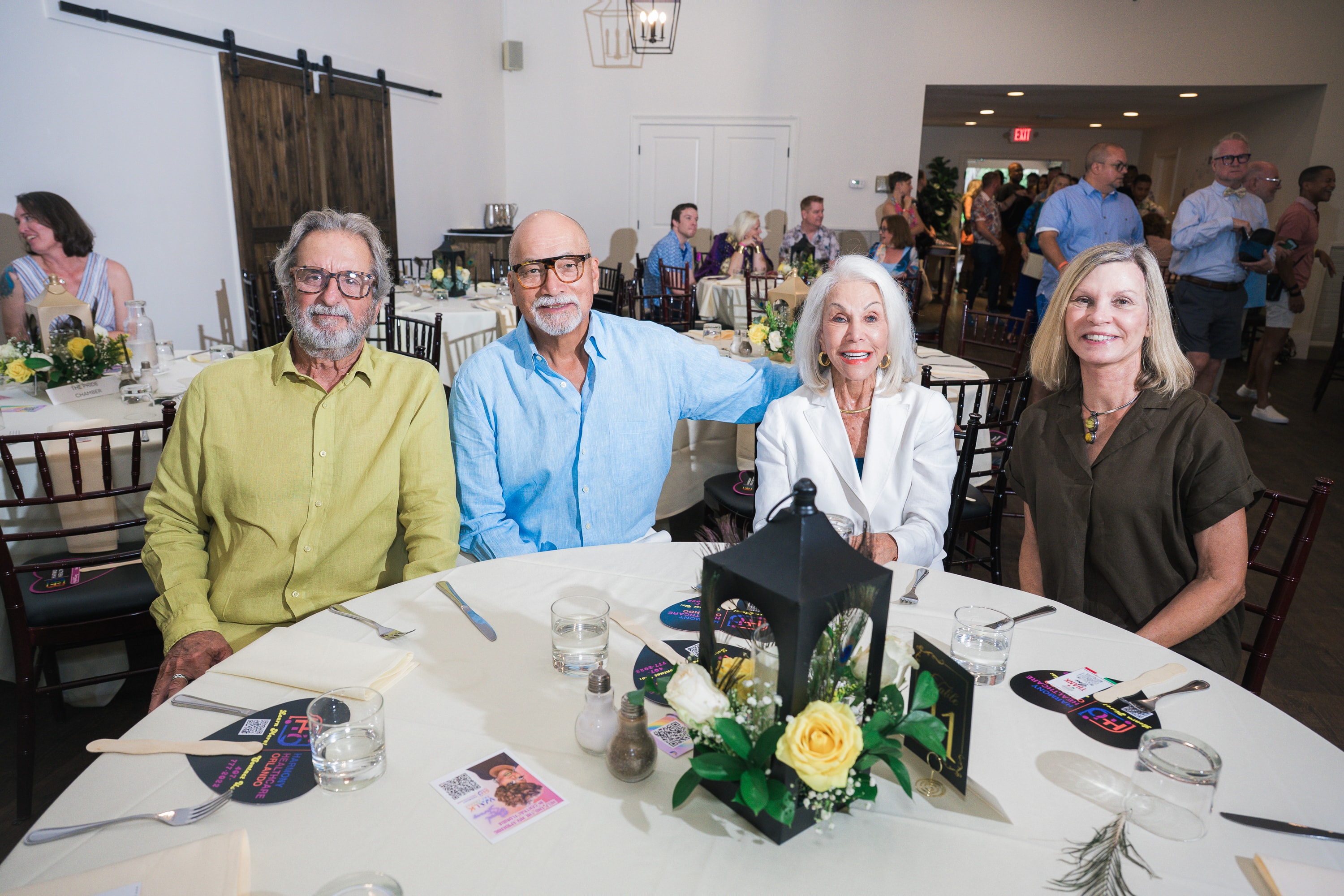 Four guests seated at a table at Peacocks & Divas 2025