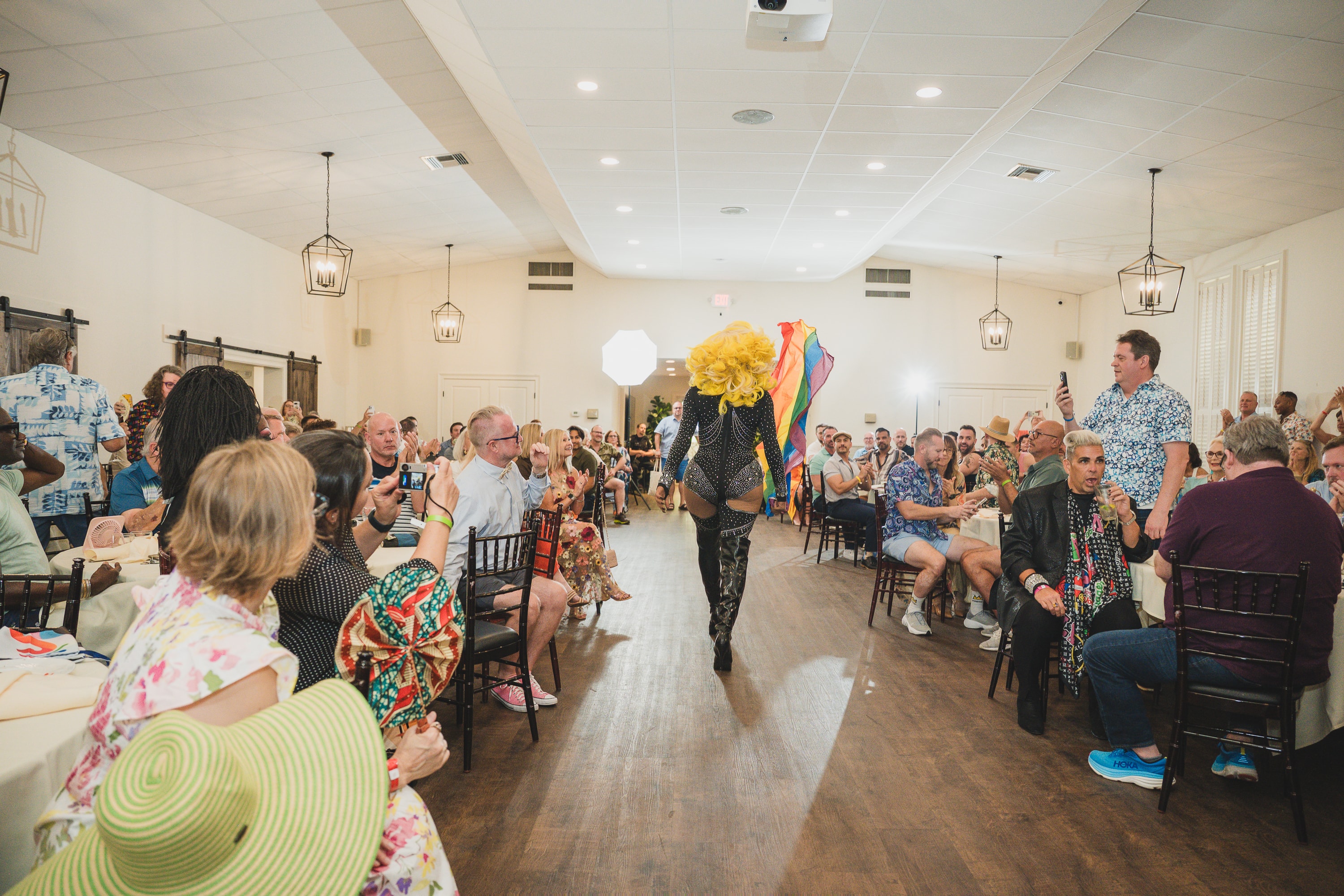 Drag performer entertaining crowd at Peacocks & Divas 2025