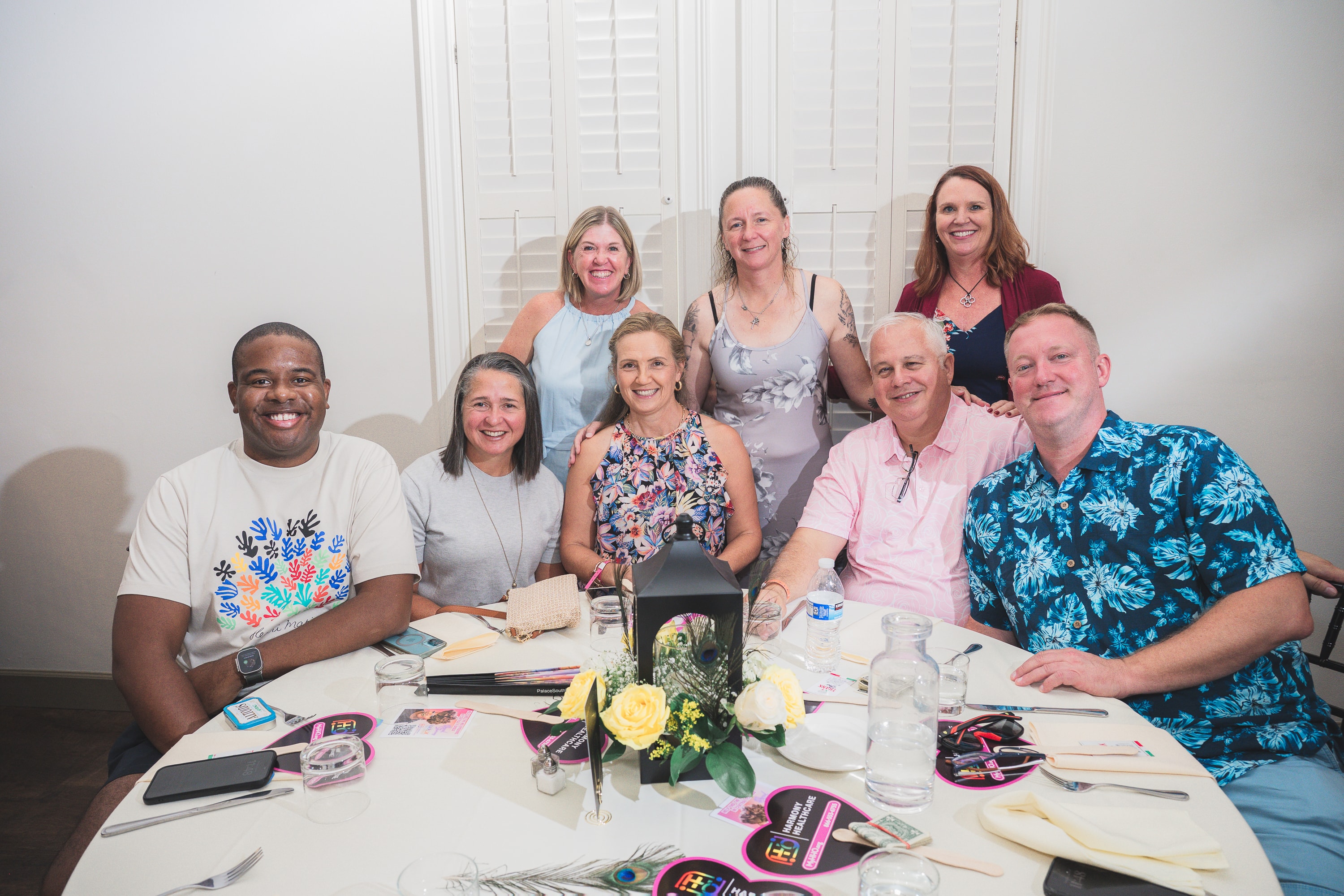 Group of guests at a table at Peacocks & Divas 2025