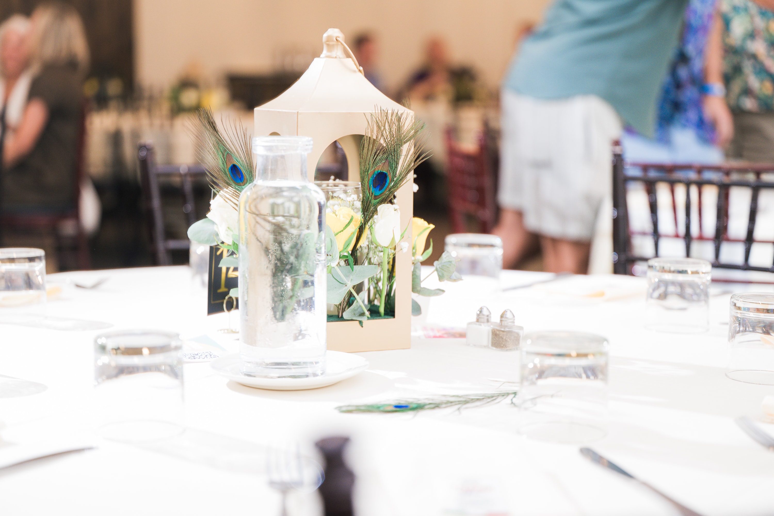 Peacock feather centerpiece at Peacocks & Divas 2025